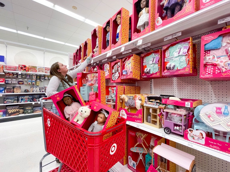 woman shopping for dolls and filling up target cart