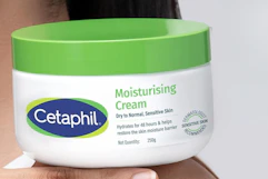 hand holding Cetaphil moisturizing cream