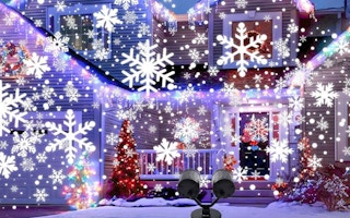 a snowflake projector on the outside of a house