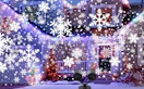 a snowflake projector on the outside of a house