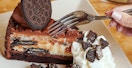 a fork digging into a piece of cheesecake