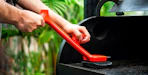 a person using a steam grill brush