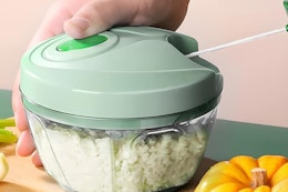 a person using a vegetable chopper