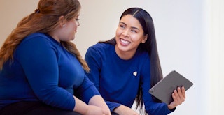 An Apple employee talking to a customer