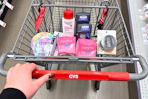 person pushing a cart with eucerin, dove, carefree, covergirl, and vitamasques products