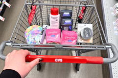 person pushing a cart with eucerin, dove, carefree, covergirl, and vitamasques products