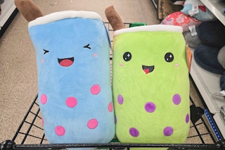 blue and green large boba plushes in a cart