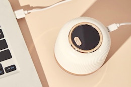 a fabric shaver plugged into a laptop charging