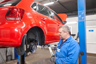A mechanic repairing a car brake