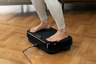 a woman using a vibration plate