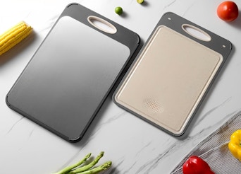 two cutting boards on a table 