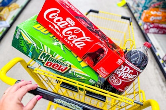 soda products stacked in a dollar general shopping cart