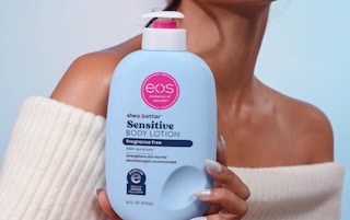 a person holding a bottle of lotion