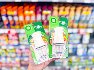 hand holding two Air Wick diffusers