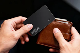 person pulling card tracker out of wallet