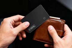 person pulling card tracker out of wallet