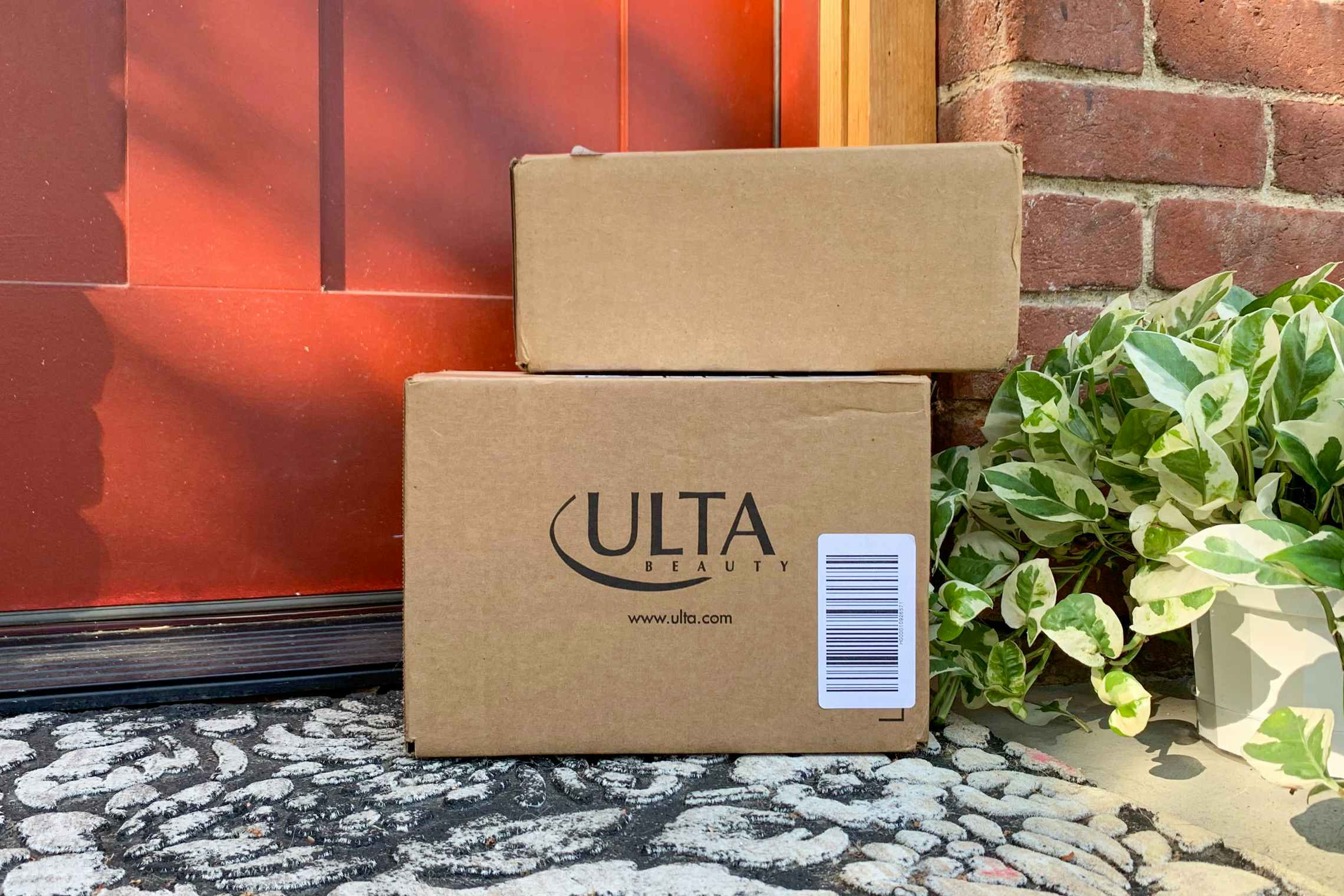 Ulta packages stacked on top of one another and sitting on someones front doorstep