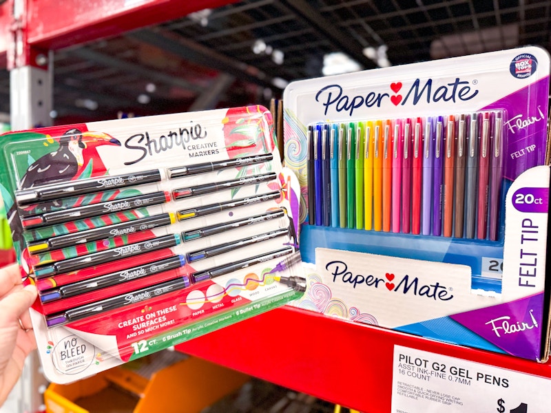 person holding a package of sharpie creative markers by paper mate flair pens