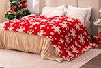 Red Sherpa Blanket - Snowflakes Throw Blanket on a bed.