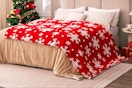 Red Sherpa Blanket - Snowflakes Throw Blanket on a bed.