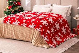 Red Sherpa Blanket - Snowflakes Throw Blanket on a bed.