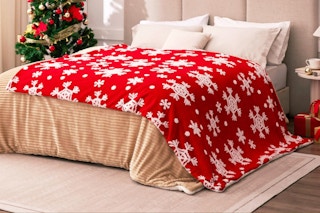 Red Sherpa Blanket - Snowflakes Throw Blanket on a bed.