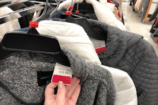a person holding up a tj maxx clearance tag