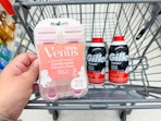 hand holding venus razors and gillette shave foams in walgreens cart