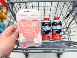 hand holding venus razors and gillette shave foams in walgreens cart