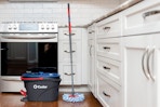 a mop and bucket in a kitchen 