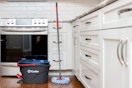 a mop and bucket in a kitchen