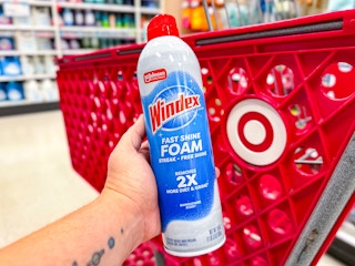hand holding windex foam spray in front of a target cart
