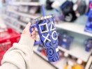 hand holding a playstation tumbler in front of target