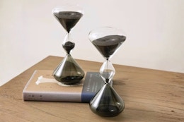 Lifestyle image of the Glitzhome Hourglass Sand Timers on table with book