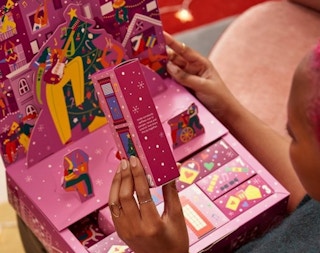 woman opening advent calendar