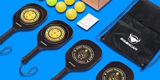 a pickleball set on laid out on a blue background