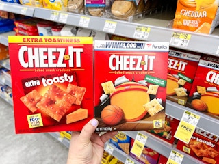 hand holding two boxes of cheez its