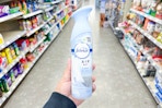 hand holding a bottle of febreze air in a store aisle