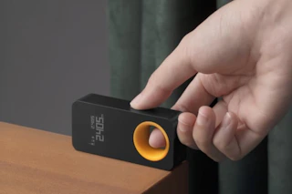 a man using a laser measuring tool