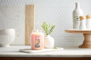 yankee candle on kitchen counter with various home decor items