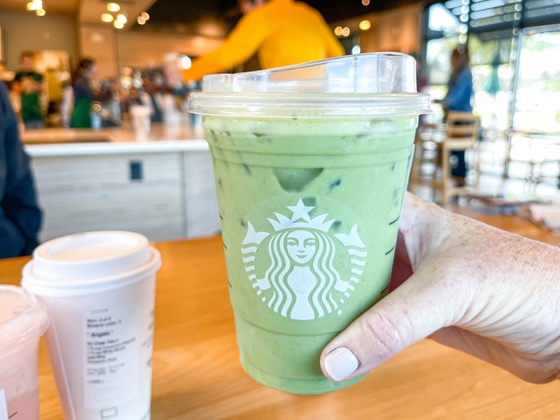 a starbucks drink being grabbed in starbucks