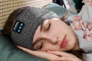 Woman sleeping with a bluetooth headband.
