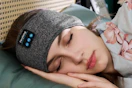 Woman sleeping with a bluetooth headband.