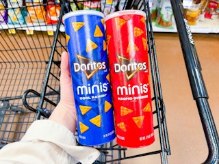 hand holding frito lay minis canisters