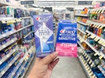 hand holding crest whitening serum and whitestrips in walgreens