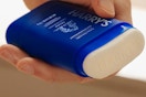 person holding a stick of Harry's deodorant