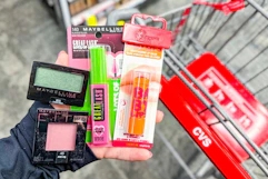 hand holding maybelline cosmetics