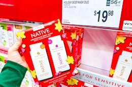 hand holding a pack of native body wash