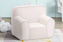 Lifestyle image of a pink Olive & Opie Kuddiez Kids Chair in home setting