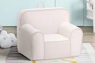 Lifestyle image of a pink Olive & Opie Kuddiez Kids Chair in home setting